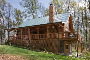 Built into the side of a hill, the home has a walkout basement. “Eventually, we want to finish it with some extra bedrooms or an apartment,” says Christine. The aluminum roof came from a local supplier. “I went with the metal roof because it was the most long-lasting, and it looked good with the trees,” she says.