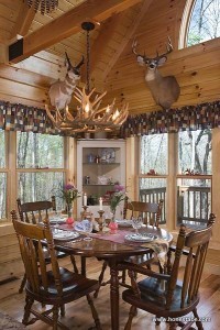 Sharron Bilbrey of Honest Abe Log Homes describes the house as “a warm, cozy little hunter’s cabin.” The antler chandelier came from Black Forest Decor.