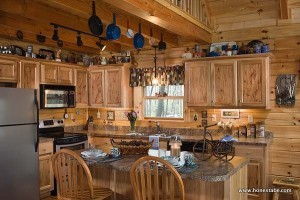 In the kitchen, pots and pans hang from nails on the rafters. Like the walls, the floors throughout the home are all wood. “We didn’t put any drywall or tile in our house at all,” Christine says.