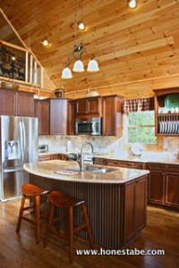 The kitchen features a striking contrast of dark and light woods.