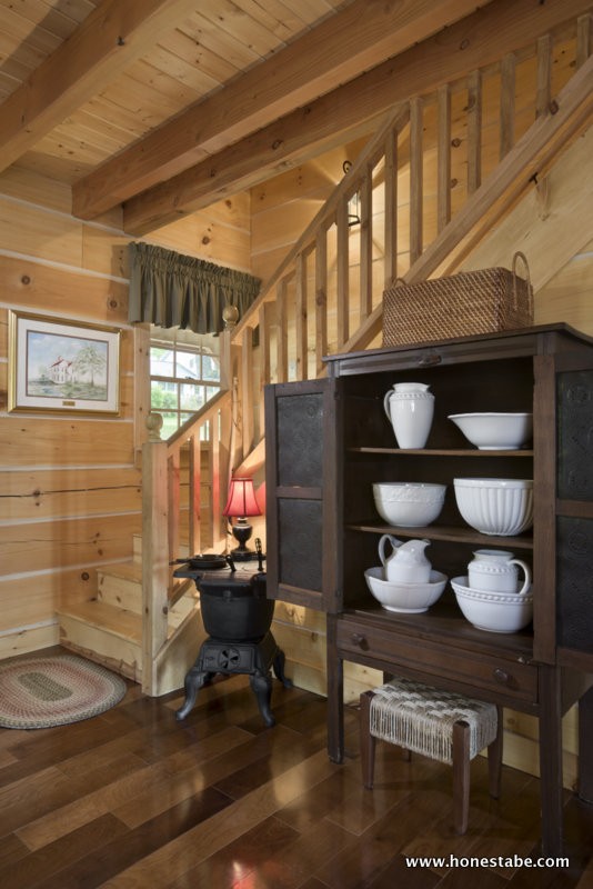 Interior, vertical, stairway with antique pie safe and potbelly stove, Clayton residence, Crossville, Tennessee; Honest Abe Log Homes